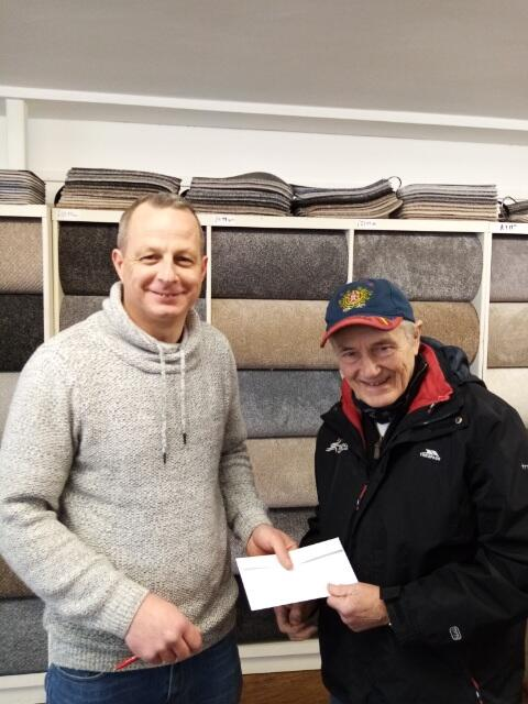 Paddy Gardiner of P.Gardiner Carpets hands over a cheque for Jimmy’s 10K to Joe Quinn.